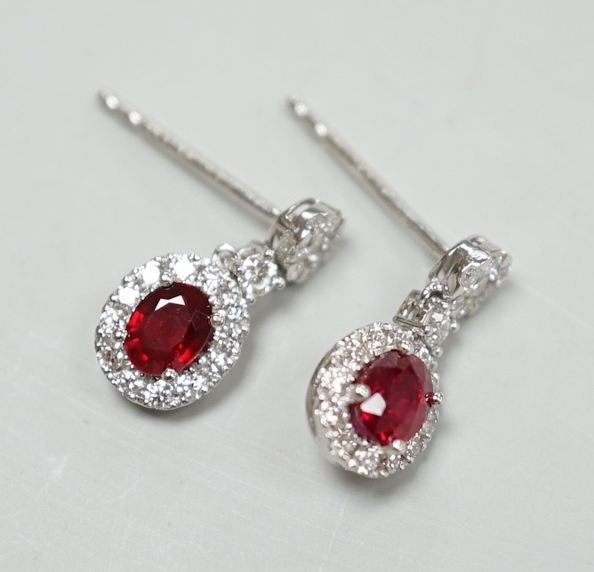 A modern pair of 750 white metal, ruby and diamond cluster set drop earrings, 13mm, gross weight 2.3 grams.